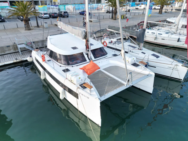 Location de catamaran privé à Barcelone - bateau de fête au Port Olímpic avec des invités sur le pont